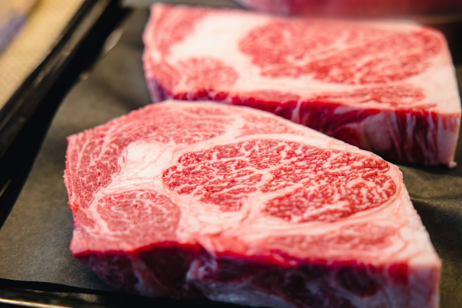 Richly marbled raw beef steaks, shown as serving inspiration