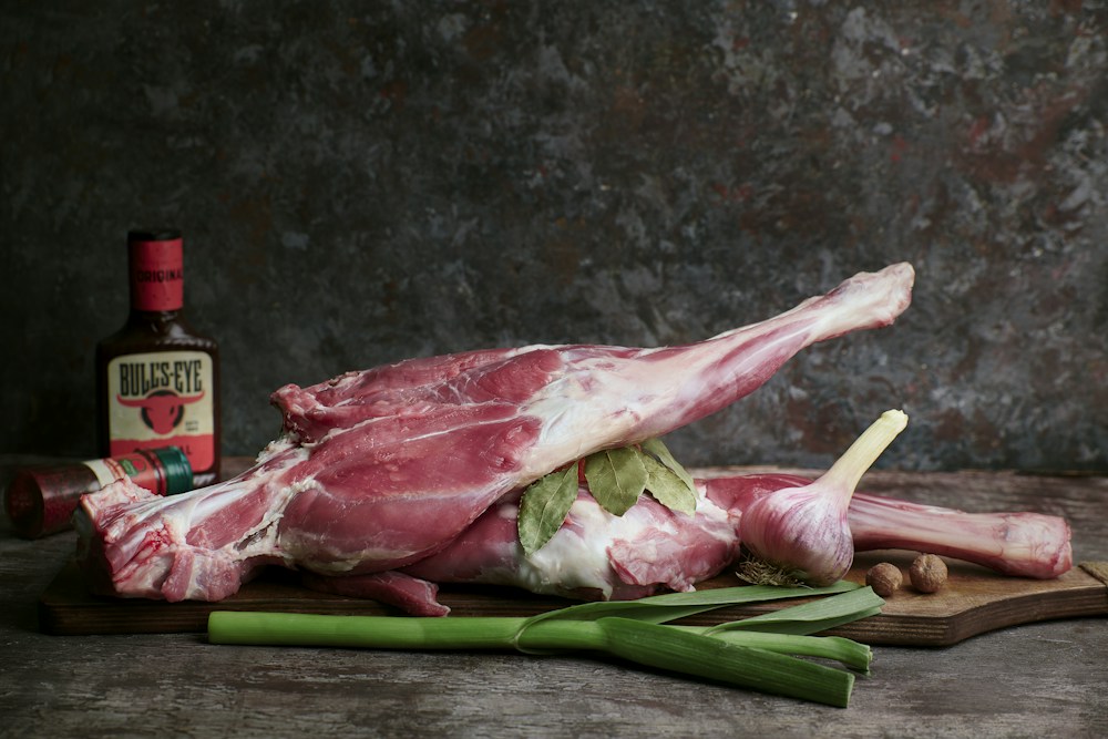 Raw bone-in lamb with herbs and garlic